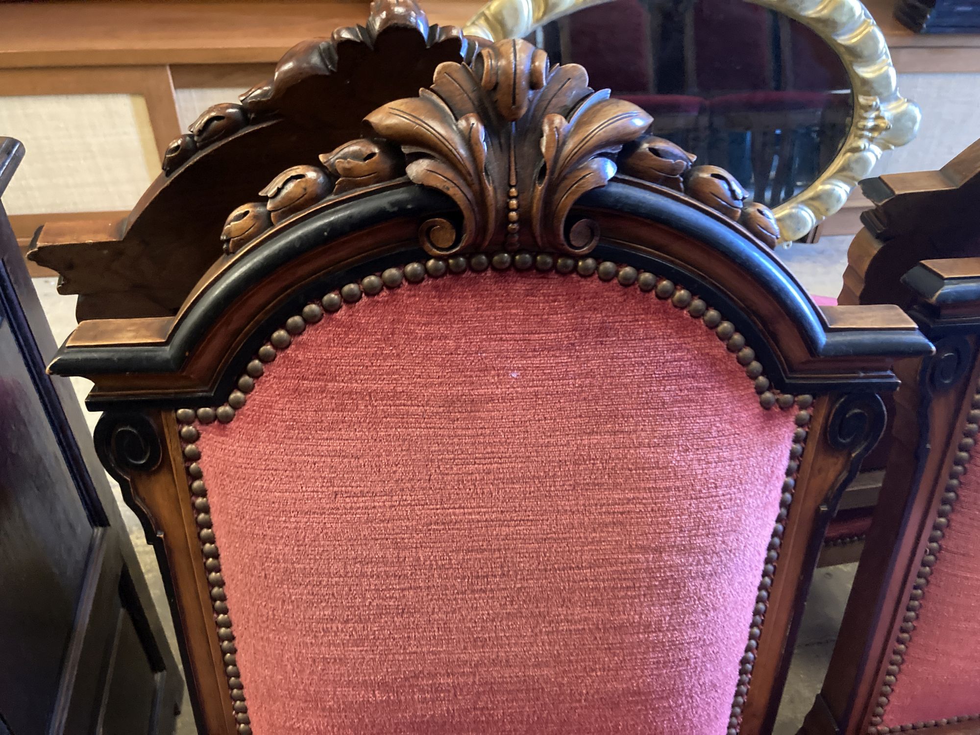 A set of twelve 19th century Continental walnut part ebonised carved walnut dining chairs